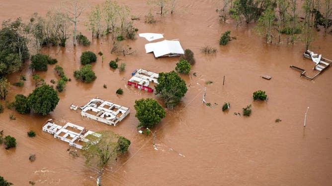 Watch: Soldier in Brazil hammers through roof to save baby from flood